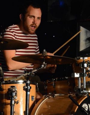 Matt playing the drums. His mouth is wide open